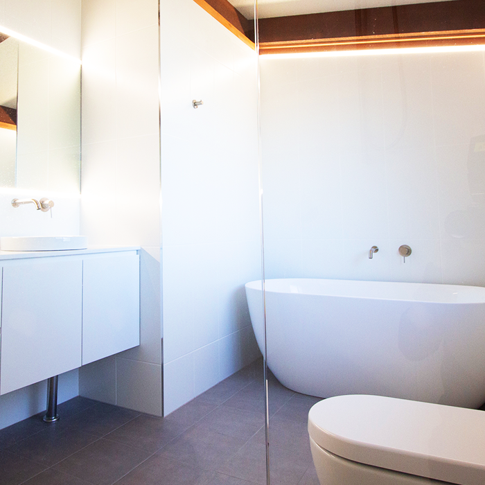 White bathroom with standing bathtub