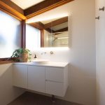 White tiled bathroom with floating sink counter