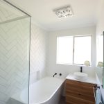 White bathroom with wooden accents