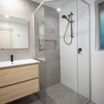 Tiled bathroom with wooden accents