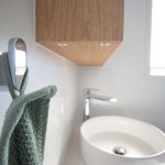 White bathroom with wooden accents