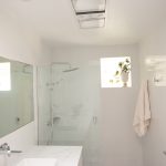 White tile bathroom with marble countertop