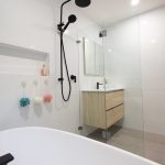 White bathroom with wooden accents