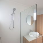 White bathroom with wooden accents