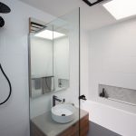 White bathroom with wooden accents
