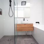 White bathroom with wooden accents