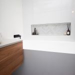 White tiled bathroom with bathtub