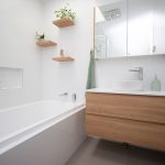 White bathroom with wooden accents