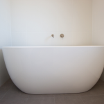 Bathtub in white tile bathroom
