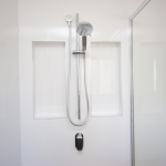 Shower in white tile bathroom